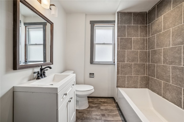 full bathroom with a wealth of natural light, vanity, hardwood / wood-style flooring, and toilet