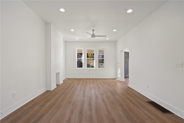 unfurnished living room featuring wood-type flooring and ceiling fan