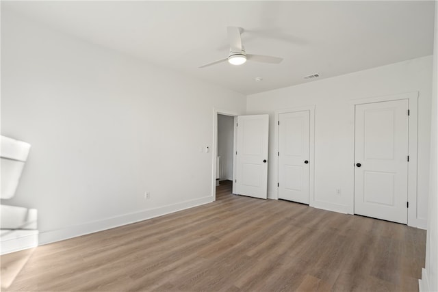 unfurnished bedroom featuring ceiling fan and light wood-type flooring