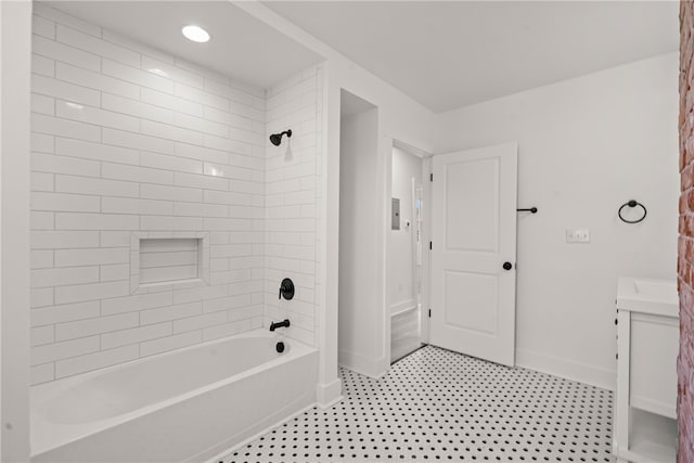 bathroom featuring vanity and tiled shower / bath