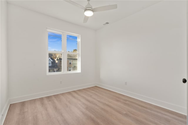 spare room with ceiling fan and light wood-type flooring