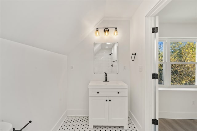 bathroom with vanity and vaulted ceiling