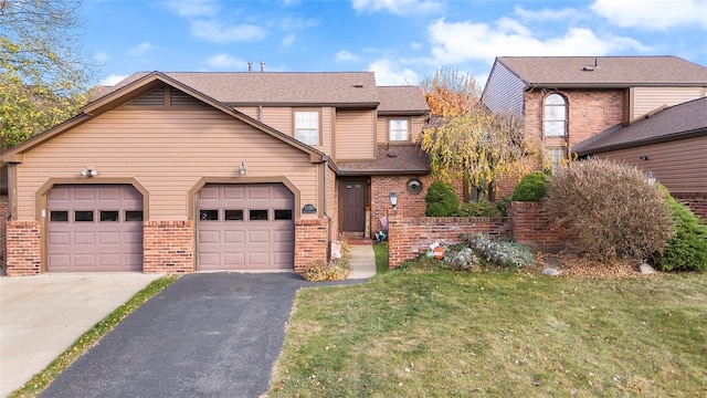 view of front of home with a front yard and a garage