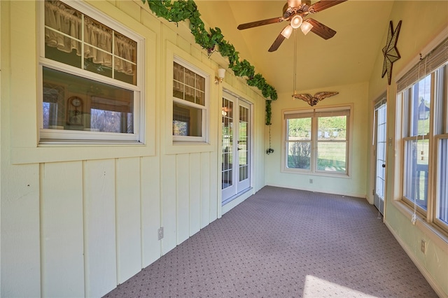 unfurnished sunroom featuring lofted ceiling and ceiling fan