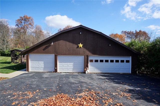 view of side of home featuring an outdoor structure and a garage