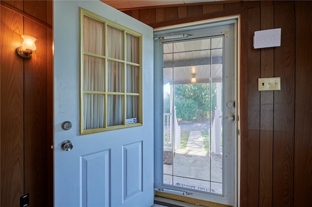 entryway featuring wooden walls