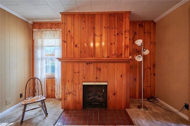 living room featuring ornamental molding, a fireplace, and wood walls