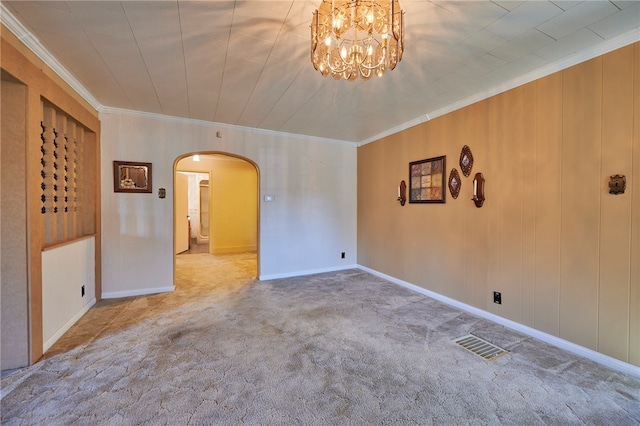 carpeted empty room featuring crown molding