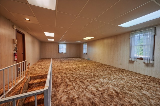 basement featuring a paneled ceiling and carpet floors