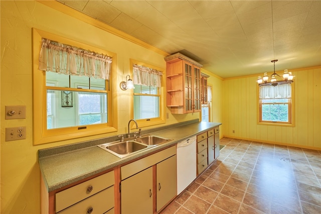 kitchen with dishwasher, ornamental molding, sink, decorative light fixtures, and an inviting chandelier