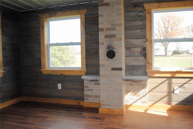 interior details featuring wood walls and wood-type flooring