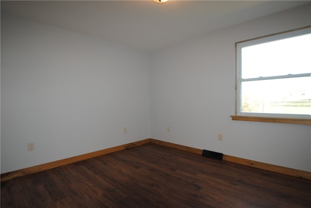 spare room with dark hardwood / wood-style floors