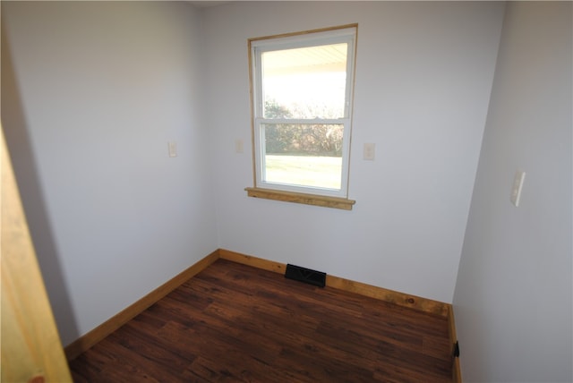 spare room featuring dark hardwood / wood-style floors