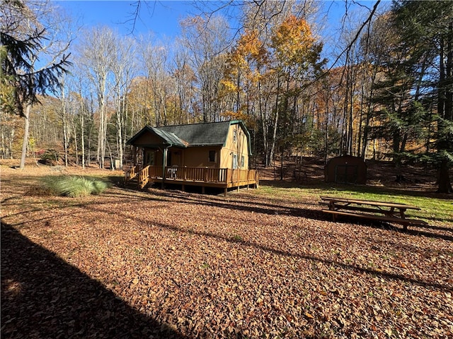 view of yard featuring a storage shed and a deck