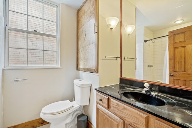 bathroom with vanity, a shower with shower curtain, and toilet