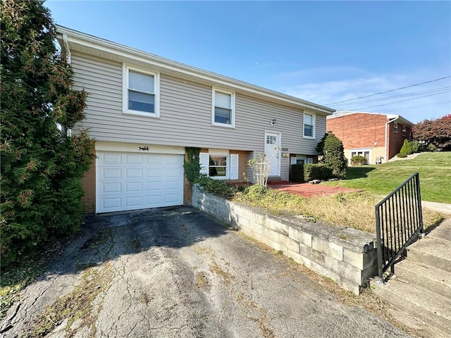 bi-level home featuring a garage and a front yard