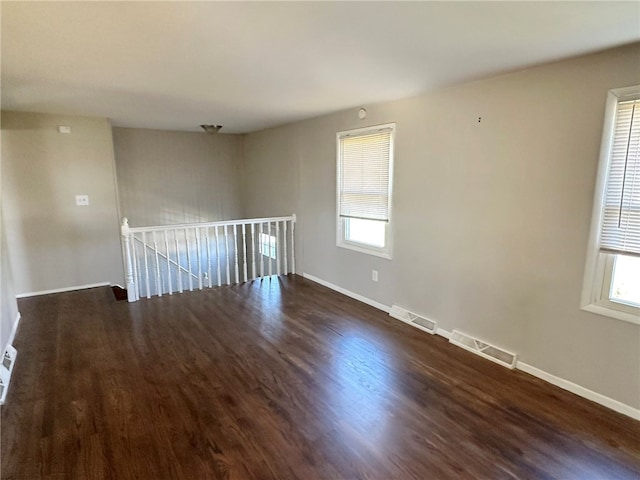 empty room featuring dark hardwood / wood-style flooring