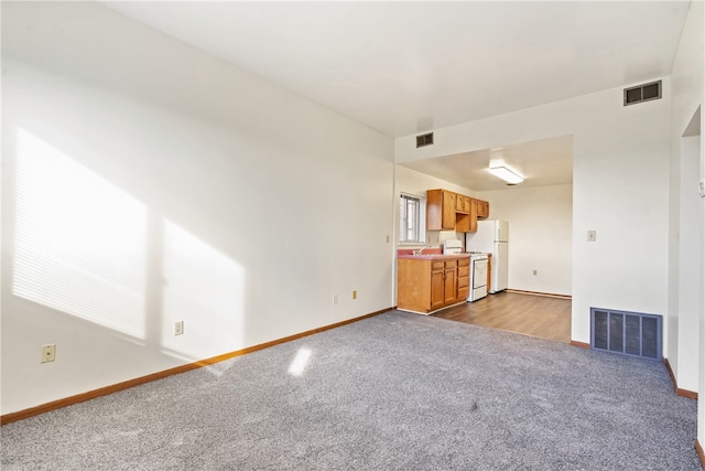 unfurnished living room featuring carpet