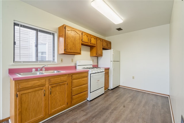 kitchen featuring light hardwood / wood-style flooring, sink, and white appliances