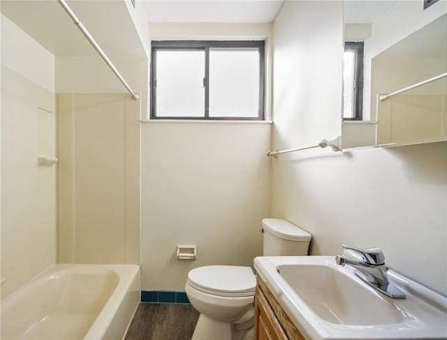 full bathroom featuring vanity, hardwood / wood-style flooring, toilet, and tub / shower combination