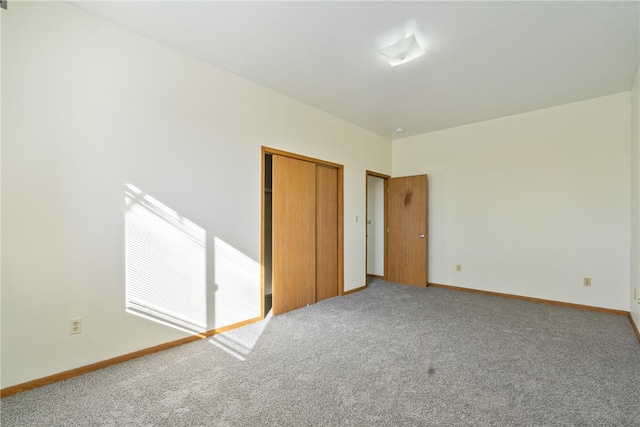 unfurnished bedroom with a closet and carpet flooring