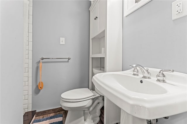 bathroom with toilet and hardwood / wood-style flooring