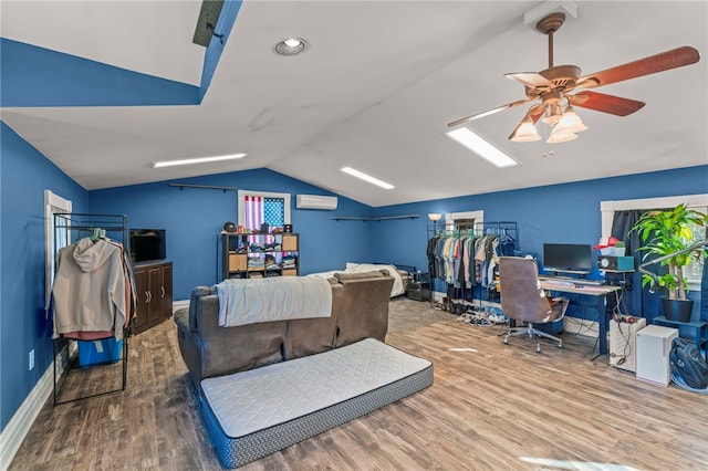 office area with ceiling fan, an AC wall unit, wood-type flooring, and lofted ceiling