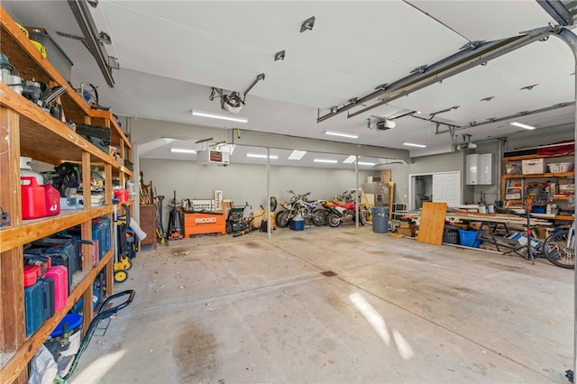 garage with a garage door opener and a workshop area