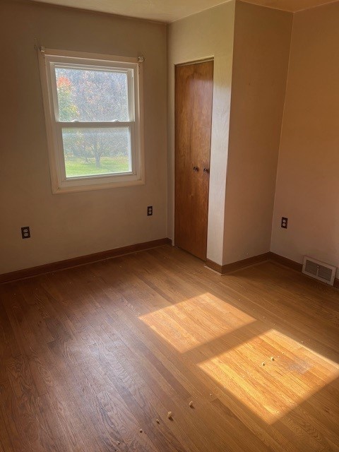 unfurnished bedroom with light wood-type flooring