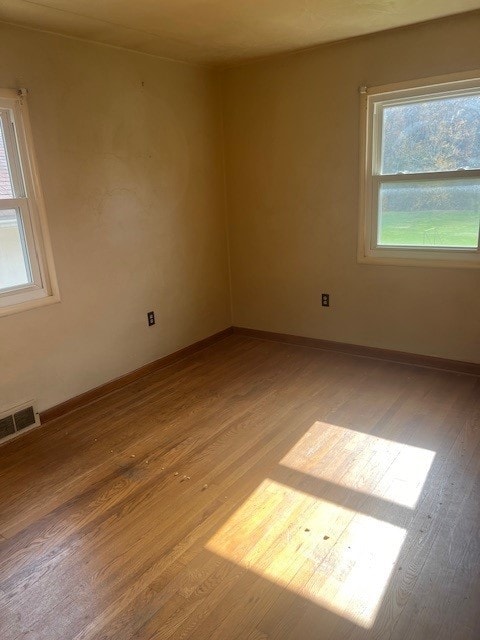 spare room with light wood-type flooring