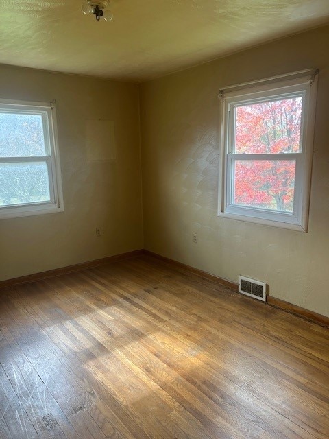 spare room featuring light hardwood / wood-style floors