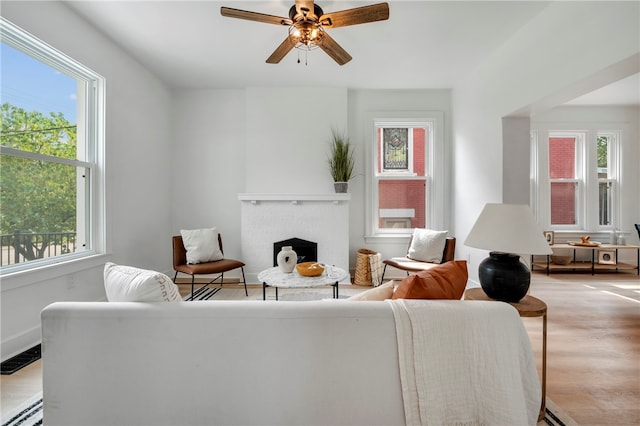 living room with plenty of natural light, light hardwood / wood-style floors, and baseboard heating