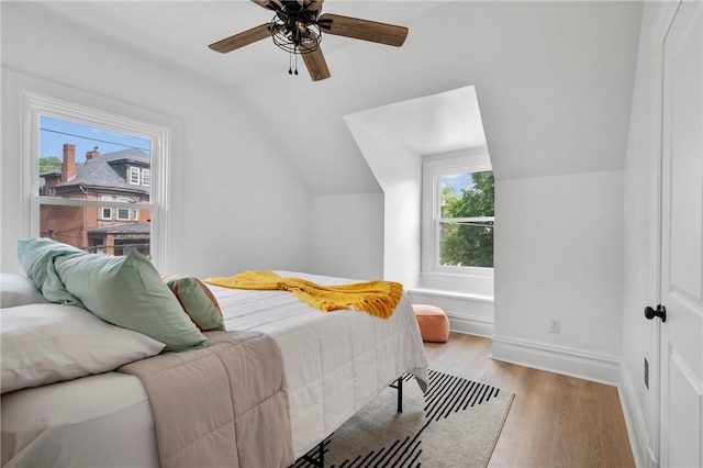 bedroom featuring ceiling fan, vaulted ceiling, and light wood-type flooring