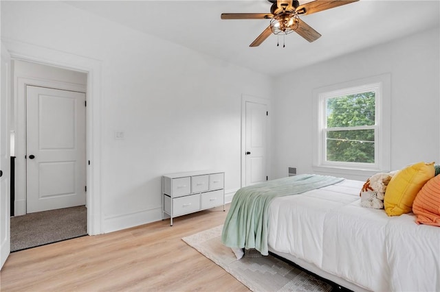 bedroom with light hardwood / wood-style flooring and ceiling fan