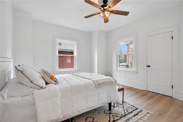 bedroom with light wood-type flooring and ceiling fan