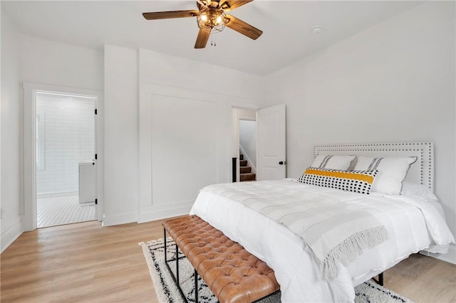 bedroom with connected bathroom, light hardwood / wood-style flooring, and ceiling fan