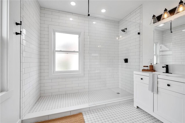 bathroom featuring vanity and a tile shower