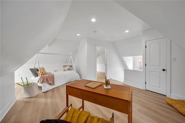 bedroom featuring vaulted ceiling and light hardwood / wood-style flooring