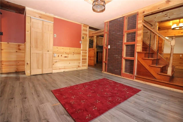 empty room with wood walls and hardwood / wood-style floors