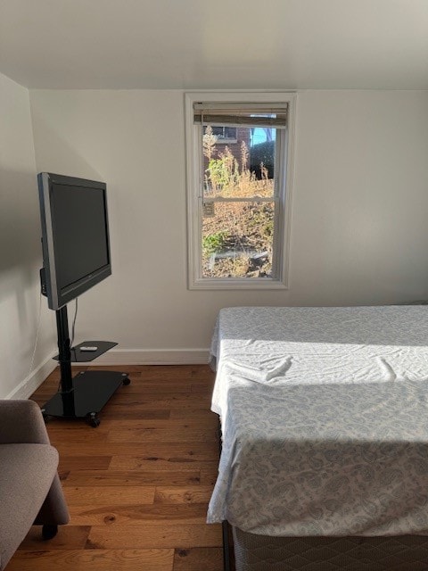 bedroom with dark wood-type flooring