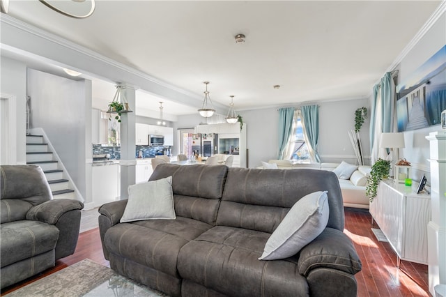 living room with ornamental molding and dark hardwood / wood-style floors