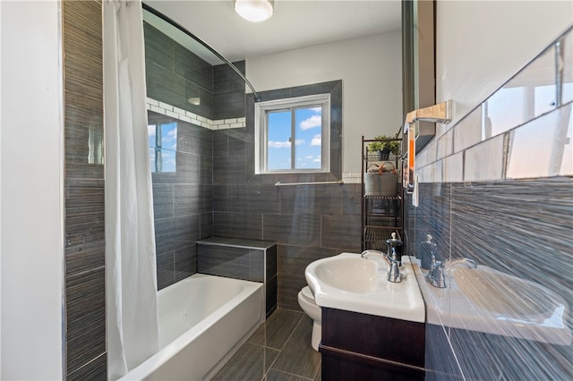 full bathroom with vanity, toilet, tile walls, and shower / bath combo