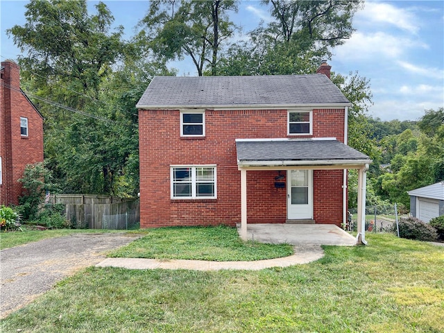 view of front of property with a front yard and a patio area