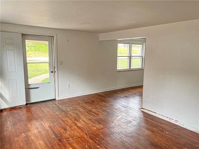 empty room featuring dark wood-type flooring