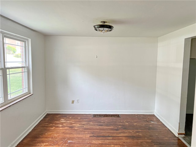 spare room featuring dark wood-type flooring