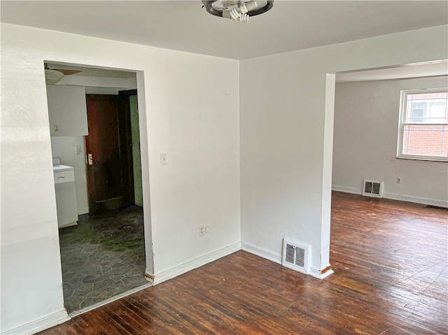 spare room with dark hardwood / wood-style flooring