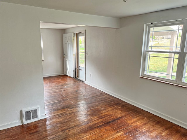 spare room featuring dark hardwood / wood-style floors