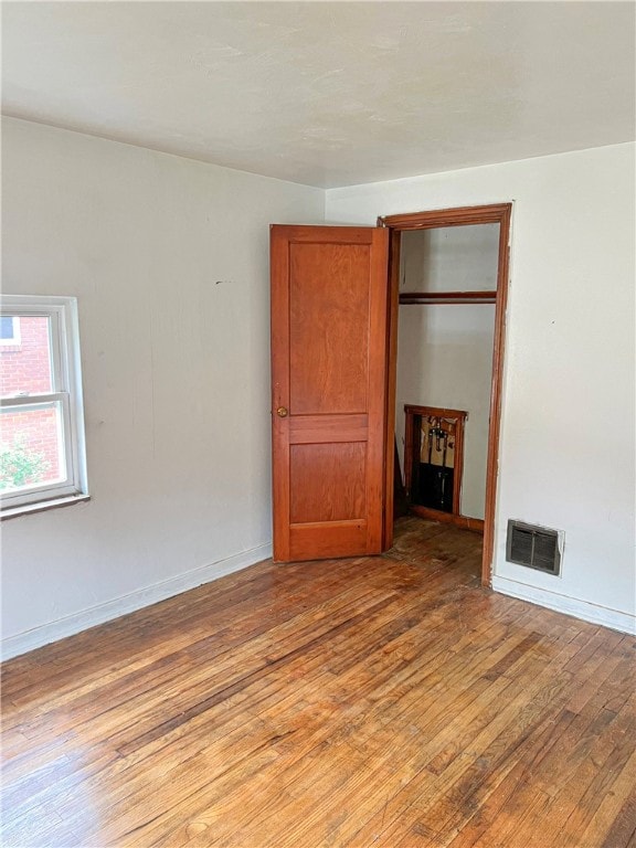 unfurnished bedroom with light hardwood / wood-style flooring and a closet