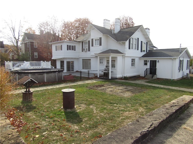 back of property with french doors, cooling unit, and a yard