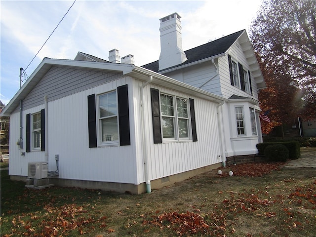 view of home's exterior featuring a lawn and ac unit